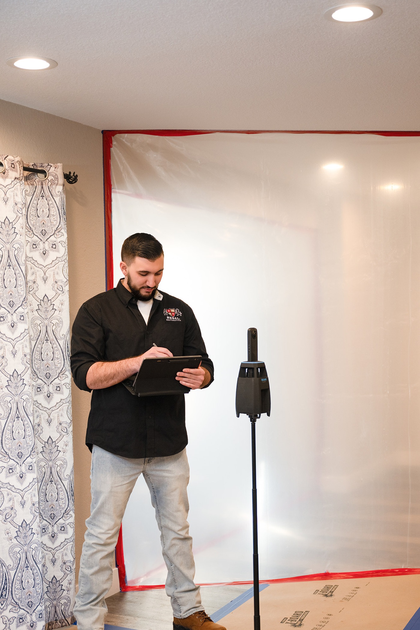 A Regal Restoration technician documenting a loss on site